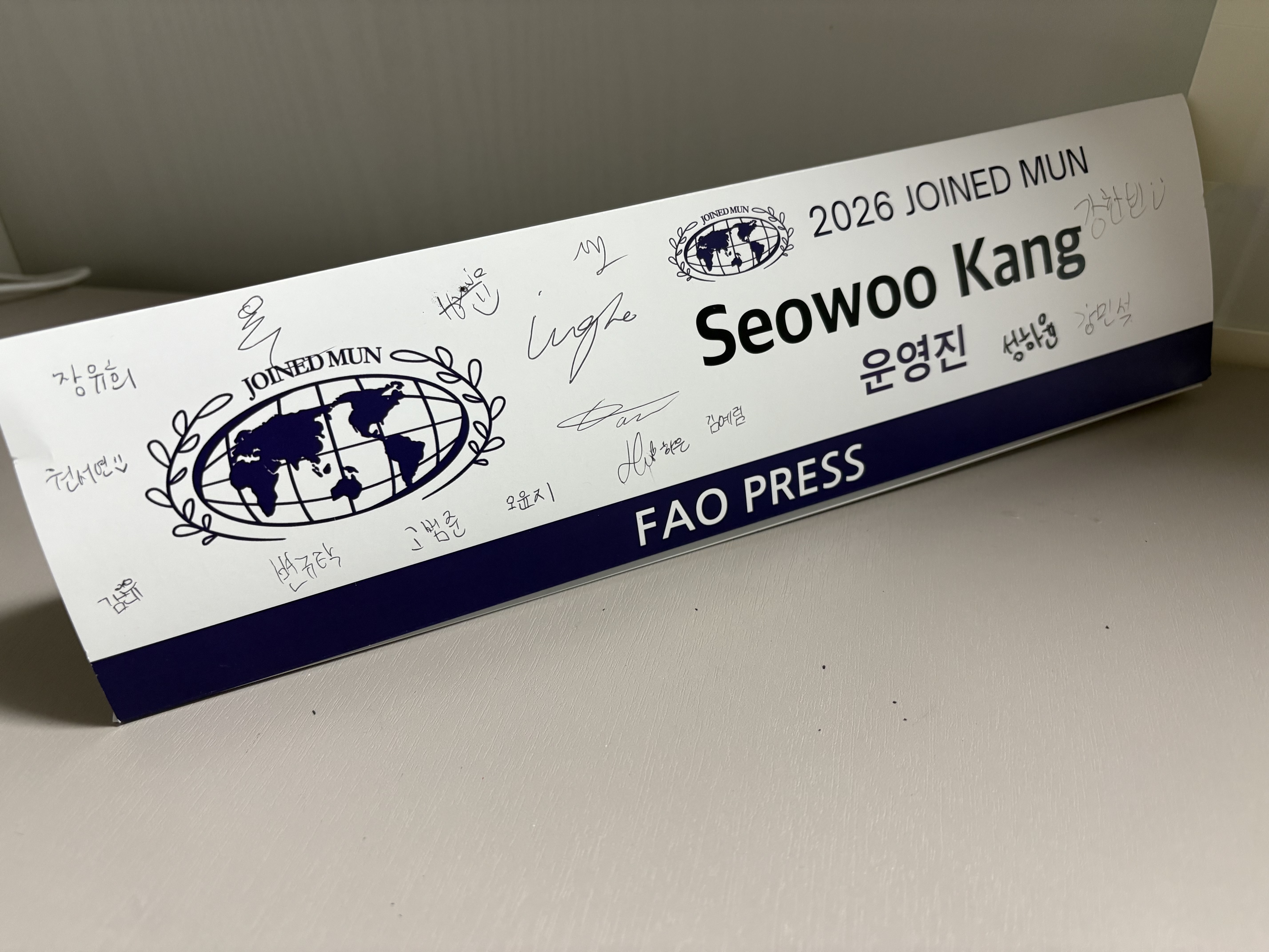 Seowoo Kang FAO Press nameplate signed with memories and signatures from friends